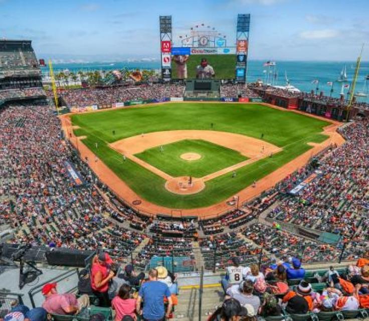 A Baseball Stadium With A Large Crowd With AT&T Park In The Background