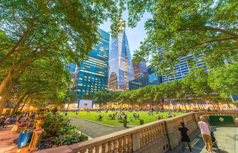 A Park With A Fountain And Tall Buildings In The Background