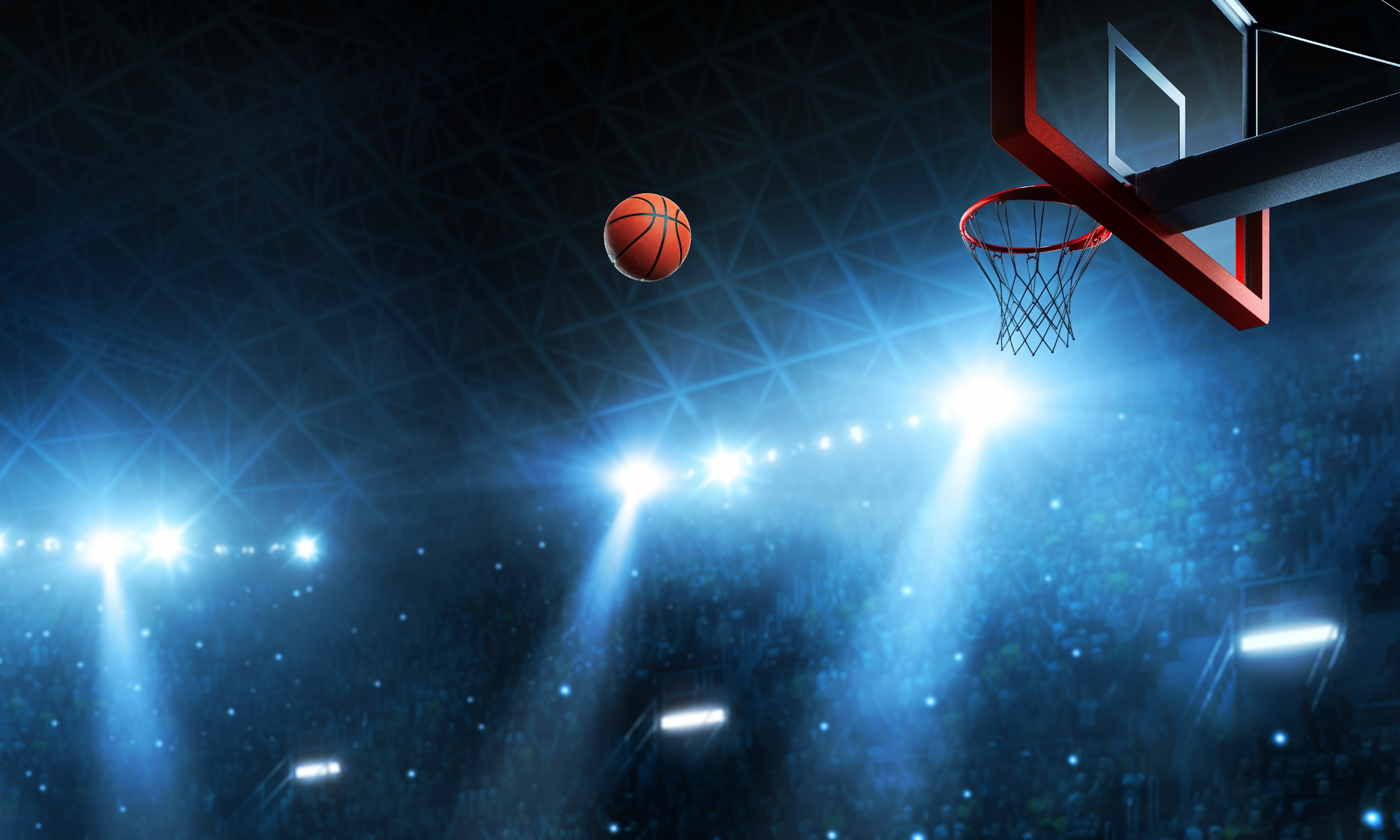 basketball and hoop with stadium lights