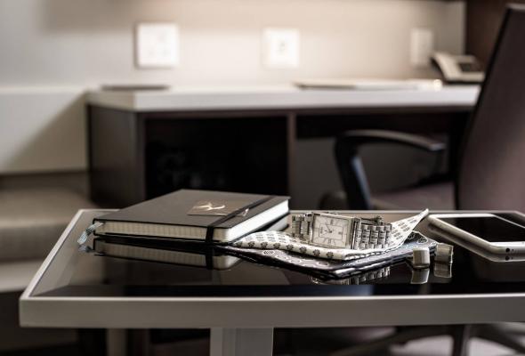 notebook and watch on a table