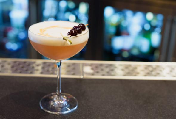 Close up of a cocktail with a cherry garnish