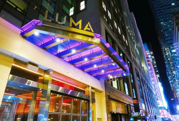 luma exterior sign lit up at night