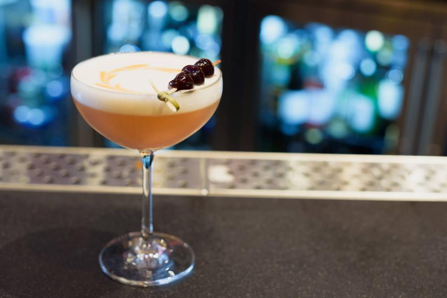 Close up of a cocktail with a cherry garnish