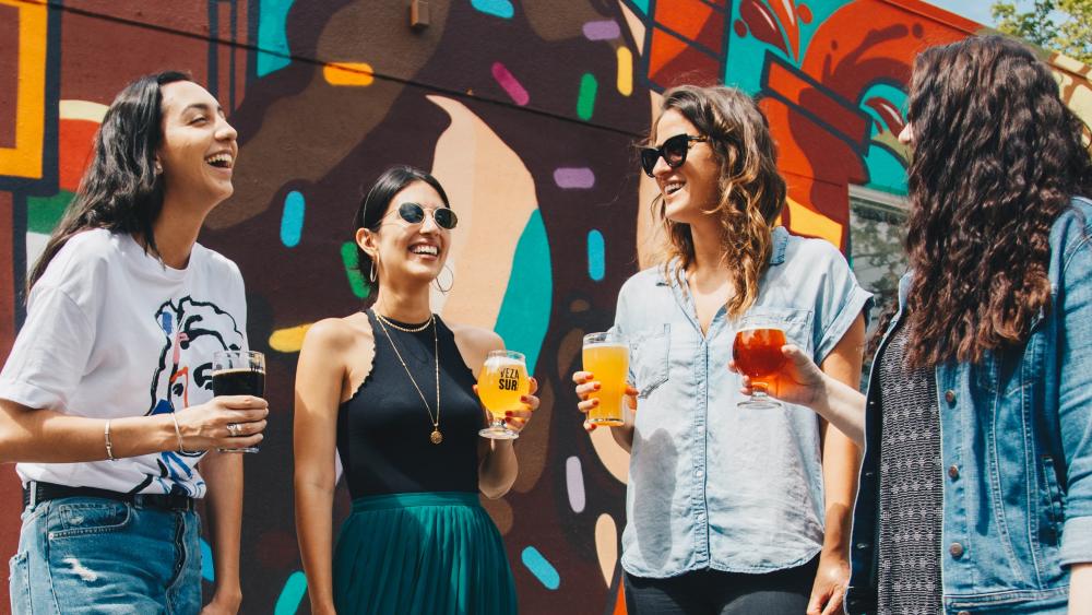 group of four females with beers