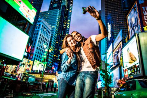 Couple taking a selfie in Times Square