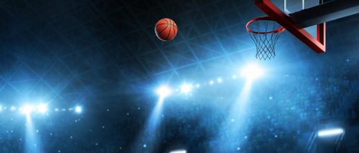 basketball and hoop with stadium lights